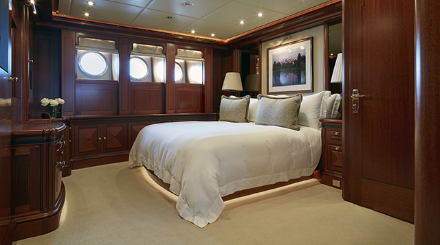 A double bed in a cabin on board the Athena superyacht