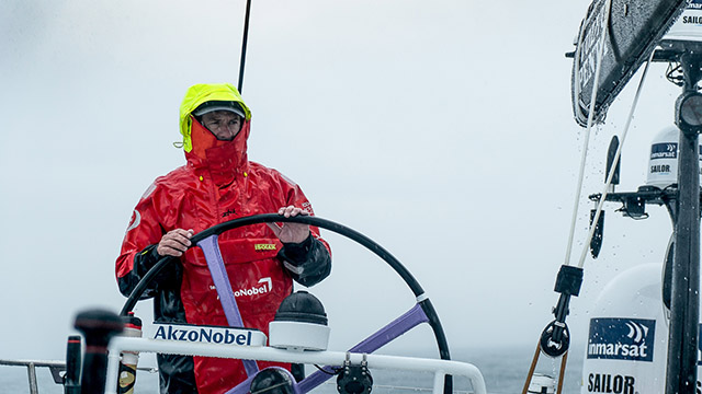 A Volvo Ocean Race 2017-18 sailor in red wet weather gear