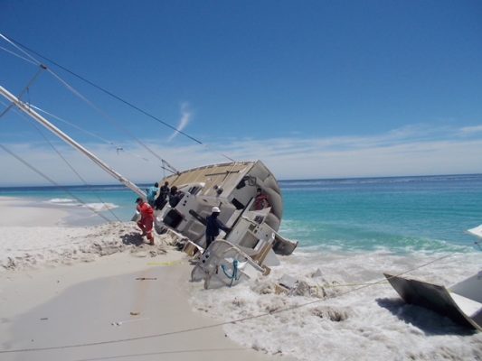 Greenings yacht aground on a beach