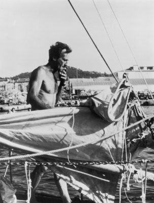 Moitessier with a cigarette in his hand on board his ketch Joshua