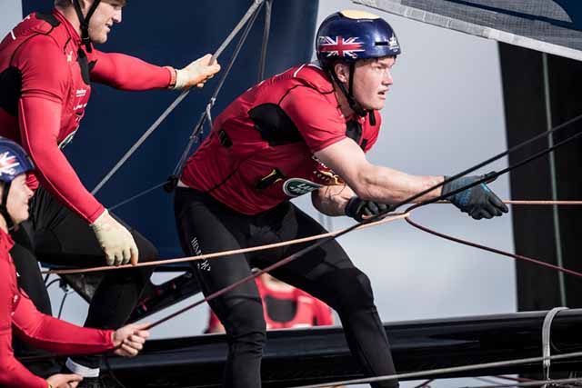 Young sailors dressed in red and wearing helmets take part in the America's Cup Red Bull Youth America's Cup