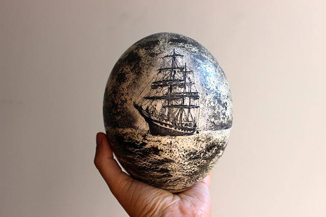 An ostrich egg with maritime scrimshaw