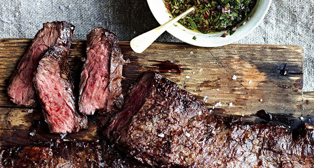 Steak on a wooden block with sauce