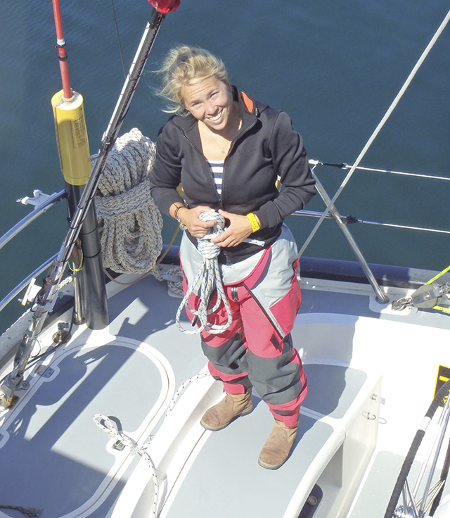 Susie Goodall wearing red and black on the deck of a yacht