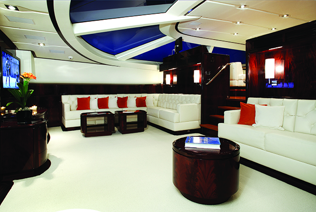 A leather white sofa and saloon with accents of red and black on board one of the most expensive sailing yachts in the world, Valquest