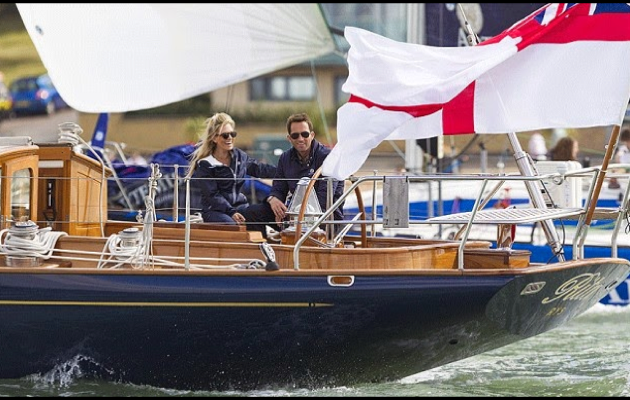 Two people on board a wooden boat